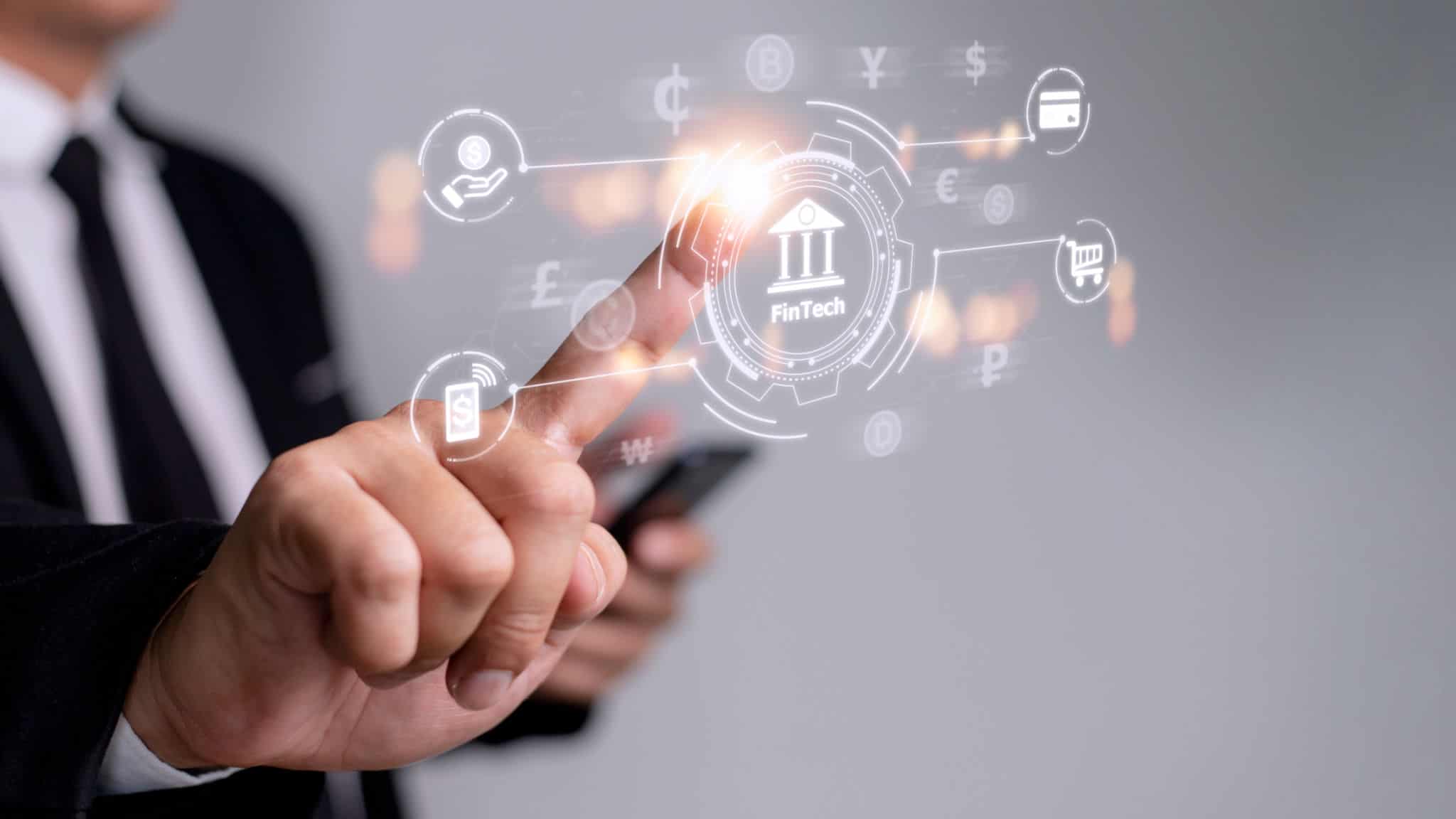 Future of financial technology concept businessman selecting fintech word